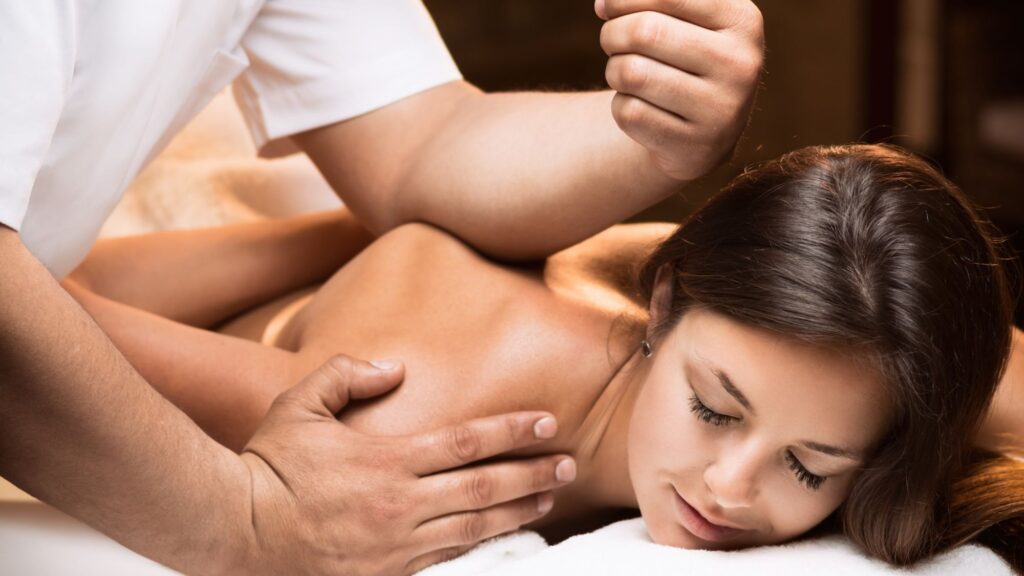 A girl getting the benefits of deep tissue massage therapy for tense muscles