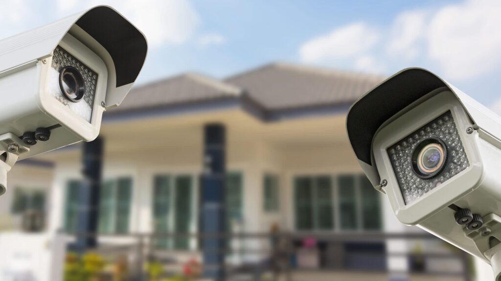 The Role of Security Systems in The Protection of Your Home Two CCTV cameras promoting the role of security systems outside a house